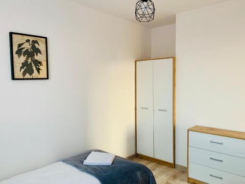 a bedroom with a bed and a dresser and a mirror at Apartament Salton in Bochnia