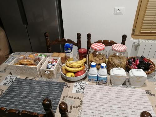 a table with a bunch of food and bottles of water at residenza " Il Gufetto" in Lombro