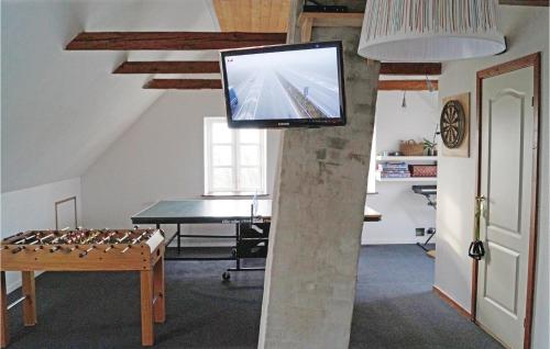 a living room with a tv and a table with a chessboard at Holiday Home Stoense Udflyttervej in Skattebølle