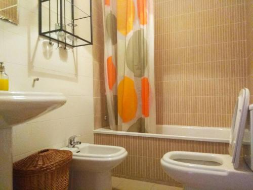 uma casa de banho com um WC, um lavatório e um chuveiro em Islantilla Palmeras Golf 2 na Islantilla