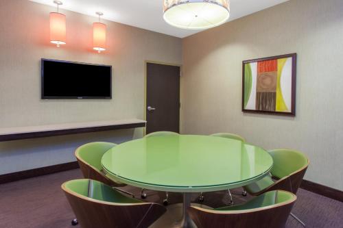 a conference room with a table and chairs and a tv at Crowne Plaza Chicago O'Hare Hotel & Conference Center, an IHG Hotel in Rosemont