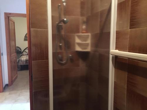 a shower with a glass door in a bathroom at Casa Nuraghe Arvu in Cala Gonone