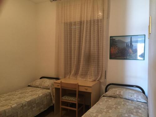カーラゴノネにあるCasa Nuraghe Arvuのベッドルーム1室(ベッド2台、窓付)