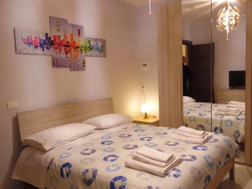 a bedroom with two beds with towels on them at B&B White One in San Prisco