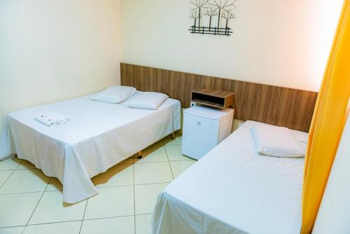 Ένα ή περισσότερα κρεβάτια σε δωμάτιο στο Hotel Trilhos de Minas
