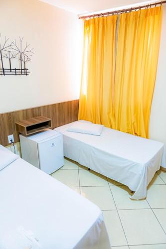 Ένα ή περισσότερα κρεβάτια σε δωμάτιο στο Hotel Trilhos de Minas