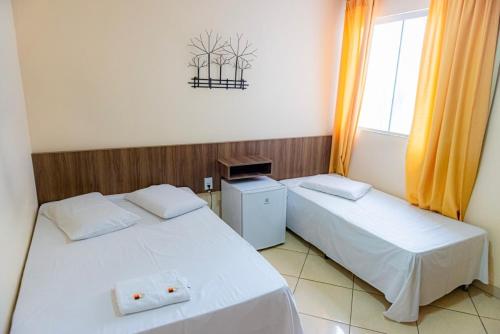 En eller flere senge i et værelse på Hotel Trilhos de Minas
