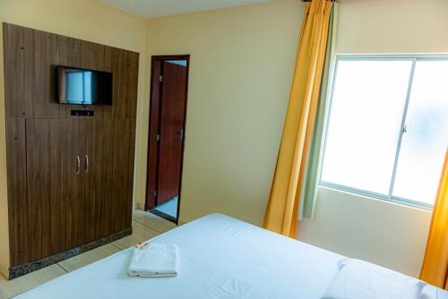 Ένα ή περισσότερα κρεβάτια σε δωμάτιο στο Hotel Trilhos de Minas
