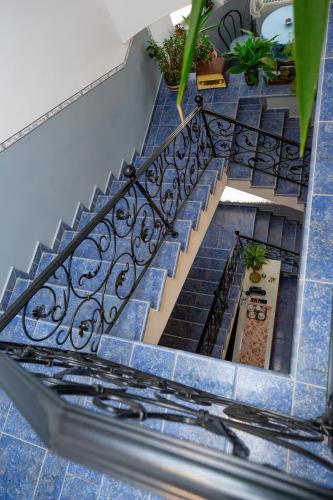 a set of stairs with blue tiles at Villa Rosa in Hajdúszoboszló