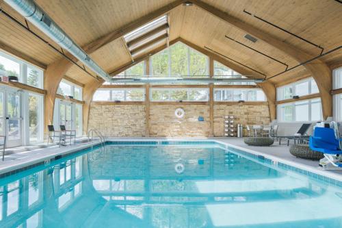 a swimming pool in a building with a large window at Crowne Plaza Chicago SW - Burr Ridge by IHG in Burr Ridge