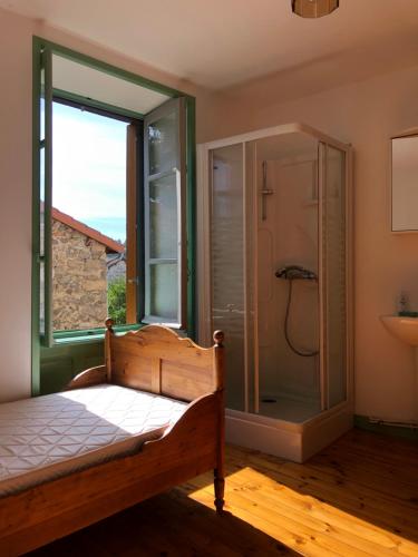 a bedroom with a shower and a bed and a window at Large 100 year old house in lovely walking area in Fayet-Ronaye