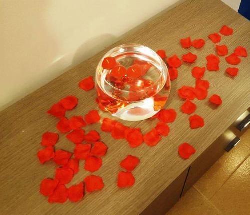a bunch of red flowers on a wooden table at La Dimora Degli Artisti in Catanzaro