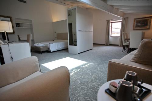 a living room with two couches and a bedroom at Albergo Accademia in Trento