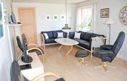 a living room with a couch and a table at Holiday Home Vesterende V in Ballum