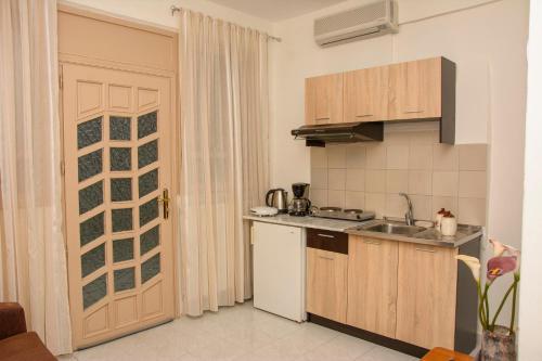 a kitchen with a sink and a counter top at Stefanie's Rooms in Asprovalta