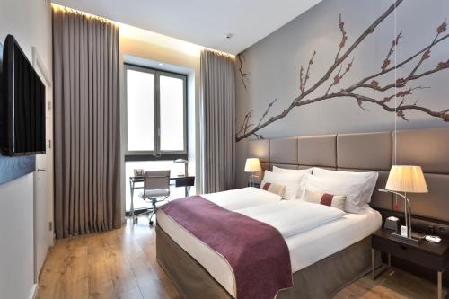 a hotel room with a large bed and a large window at Crowne Plaza Berlin - Potsdamer Platz, an IHG Hotel in Berlin