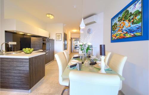 a kitchen and dining room with a table and chairs at 2 Bedroom Gorgeous Home In Krk in Krk