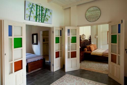 a room with a bed and a room with doors at Villa Diamond in Yogyakarta