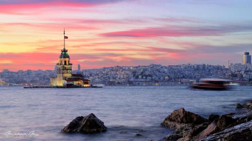 a building with a flag on it in the water at The Wolf Hotel in Istanbul