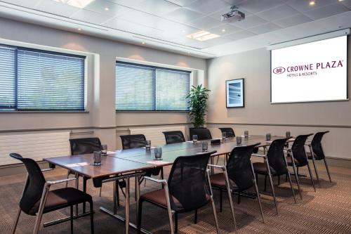 a conference room with a long table and chairs at Crowne Plaza Birmingham NEC by IHG in Bickenhill