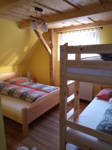 a bedroom with two bunk beds and a window at Drevenica MAK Oliver in Kvačany