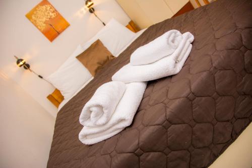 a hotel room with white towels on a bed at Stefanie's Rooms in Asprovalta