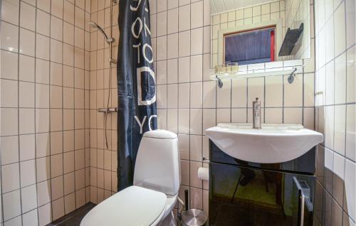 a bathroom with a toilet and a sink at Awesome Apartment In Ebeltoft With Outdoor Swimming Pool in Ebeltoft