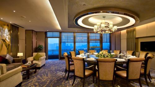 a dining room with a long table and a chandelier at Crowne Plaza Chongqing New North Zone by IHG in Chongqing