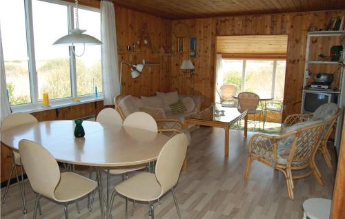 a living room with a table and chairs at Beautiful Home In Rm With Kitchen in Bolilmark