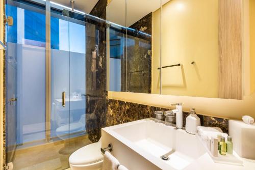 a bathroom with a sink and a shower and a toilet at Crowne Plaza Barranquilla by IHG in Barranquilla
