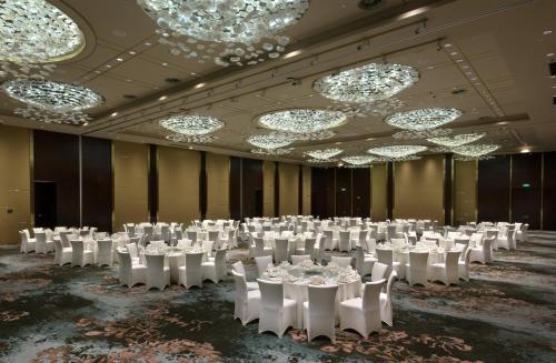 a banquet hall with white tables and chairs and chandeliers at Crowne Plaza Chongqing New North Zone by IHG in Chongqing