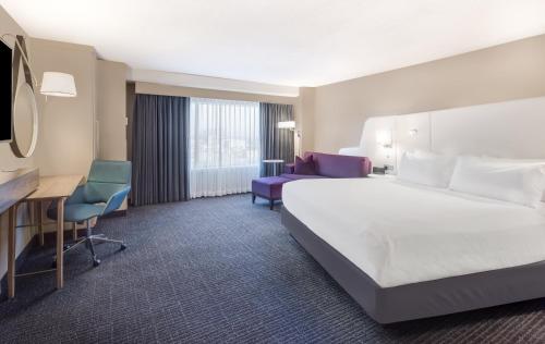 a hotel room with a large bed and a desk at Crowne Plaza Cleveland at Playhouse Square by IHG in Cleveland