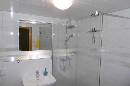 a bathroom with a glass shower and a sink at Ruegen_Fewo 72 in Gurtitz
