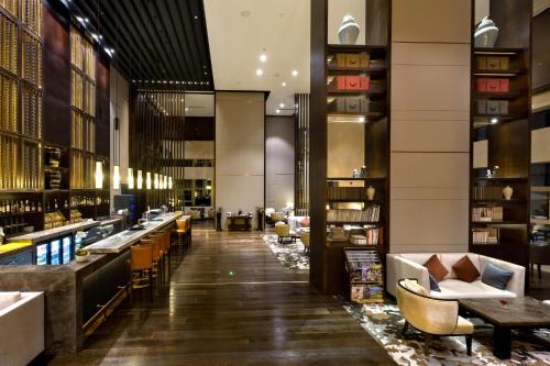 a lobby of a hotel with tables and chairs at Crowne Plaza Chongqing New North Zone by IHG in Chongqing