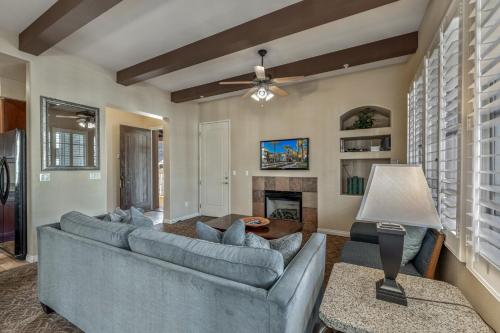 a living room with a blue couch and a fireplace at L48 Premier Location At Clubhouse Condo in La Quinta