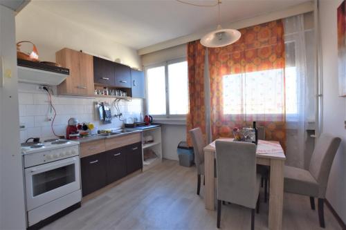 a kitchen with a table and a dining room at Autokomanda Apt. with Beautiful View near Center! in Dedinje