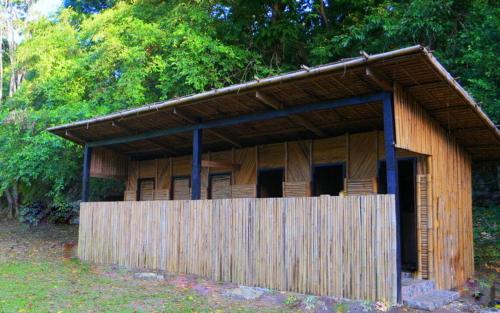 a small wooden building with a wooden fence at Pandora Glamping in Quezon