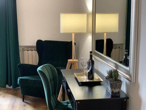 a living room with a chair and a table and a mirror at La Coroncina Lodging in Siena