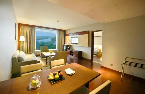 a living room with a table and a living room at Crowne Plaza Kochi by IHG in Cochin