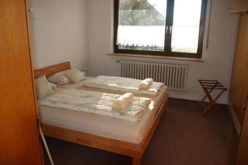 a bedroom with two beds with towels on them at Ferienwohnung Friedrich in Schonungen