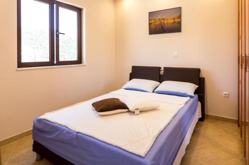 En eller flere senge i et værelse på Villa Lovric