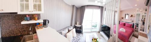 a small room with a kitchen and a living room at Sweet Seaview flr6 with toproop pool flr7 at The BluX Bangsaen in Bangsaen
