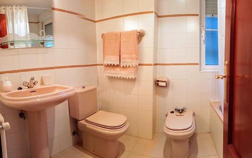 ein weißes Bad mit einem WC und einem Waschbecken in der Unterkunft APARTAMENTO ALFICA VUT-981-AS in Llanes