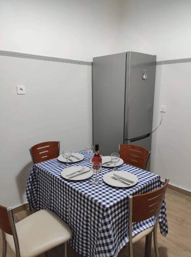 a table with a blue and white checkered table cloth at Apartment @Katehaki Metro in Athens