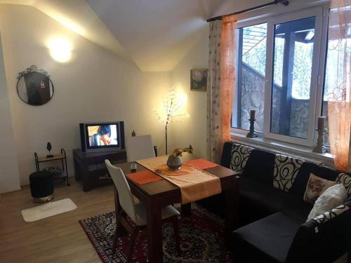 a living room with a table and a couch at Спа,ски апартамент Дайли, Стрийм Ризорт Пампорово in Pamporovo