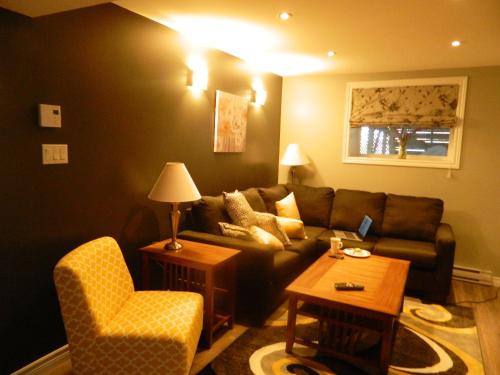 a living room with a couch and a chair at Whitsha Inn B&B in Twillingate