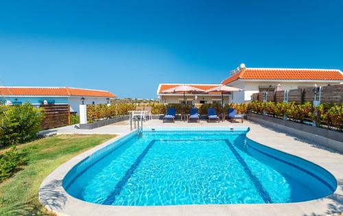 a swimming pool in the backyard of a house at Kolymbia Village in Kolimbia