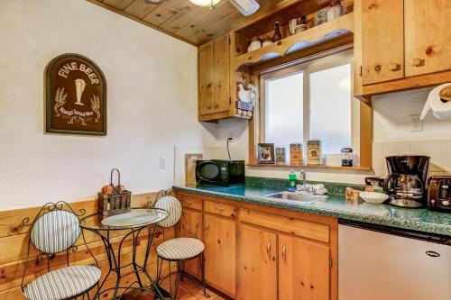 a kitchen with wooden cabinets and a counter with stools at Heavenly Valley Lodge in South Lake Tahoe