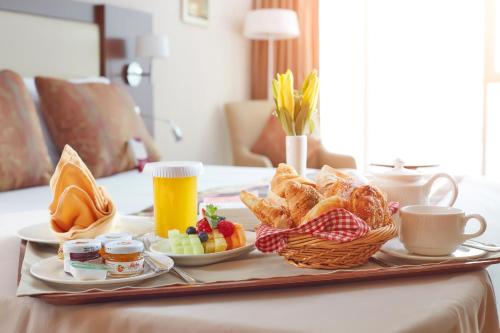a tray with breakfast foods and drinks on a table at Millennium Plaza Downtown Suites in Dubai