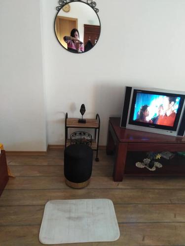 a person taking a picture of a living room with a mirror at Спа,ски апартамент Дайли, Стрийм Ризорт Пампорово in Pamporovo